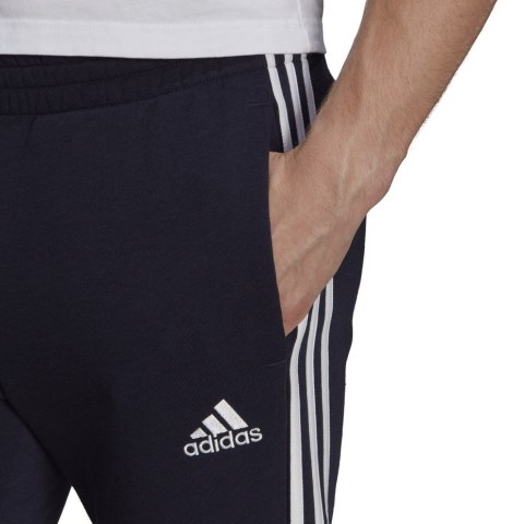 Spodnie męskie adidas Essentials Tapered Cuff 3 Stripes granatowe GK8977 Spodnie męskie adidas Essentials Tapered Cuff 3 Stripes granatowe GK8977